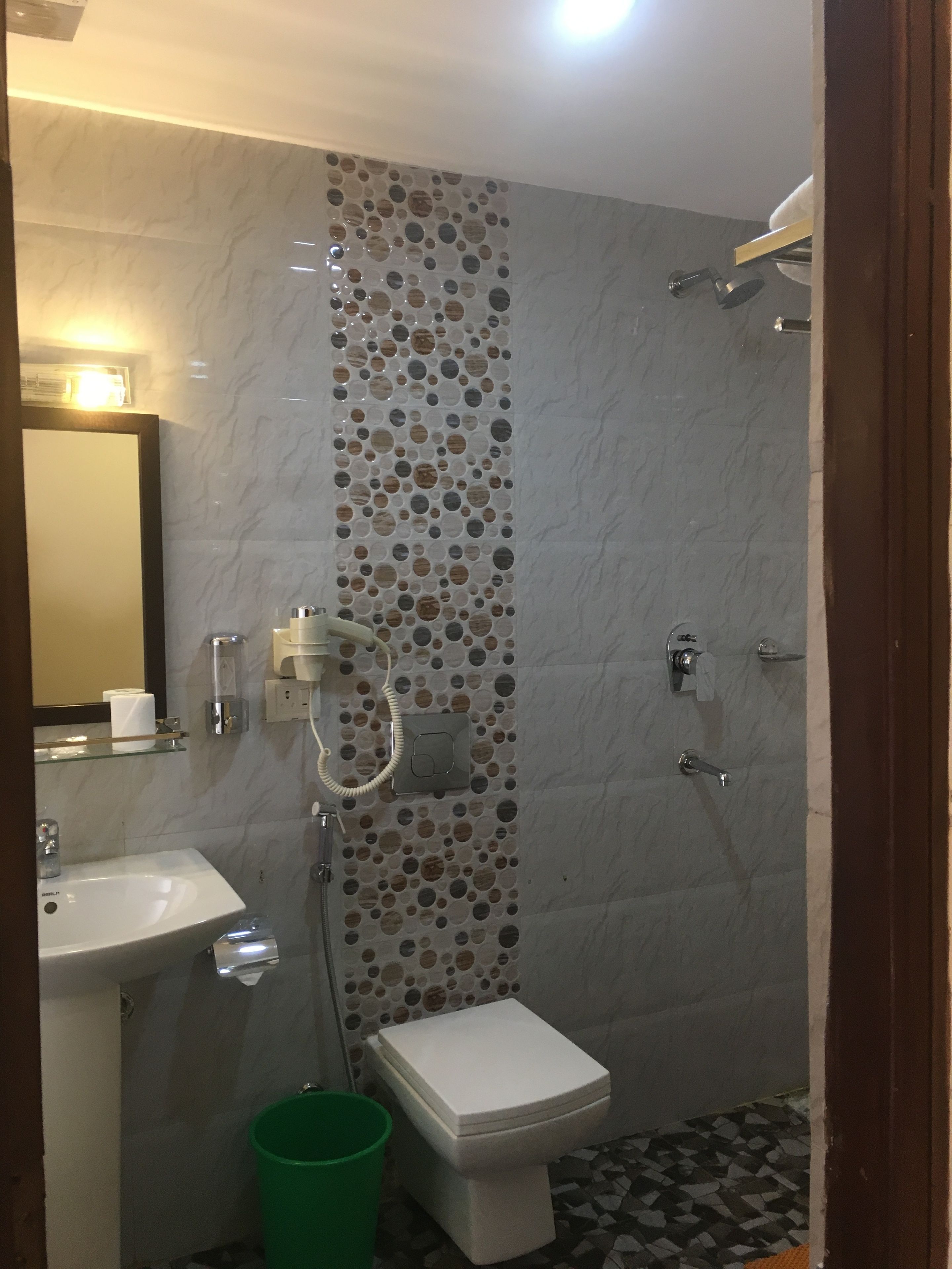 Une salle de bain équipée de toilettes, d’un lavabo et d’une douche.