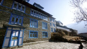 A two-story building with a sign reading "Himalayan Lodge Restaurant Namche Bazaar". - Himalayan Lodge (Namche Bazar)