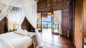 A wooden room with a bed, a canopy, and a view of the outside. - Bali Belva (Lembongan Island)