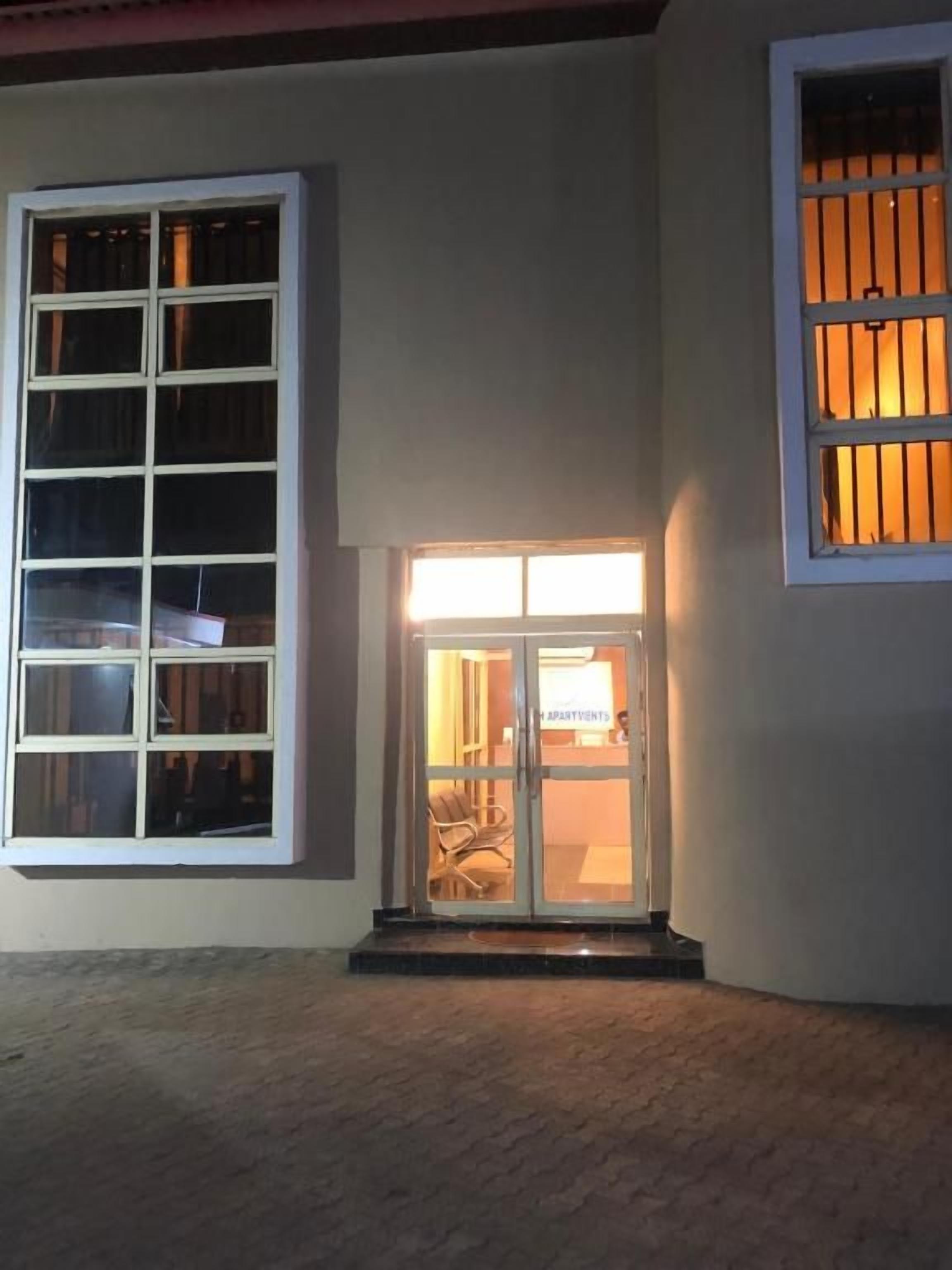 A building entrance with a glass door and windows.
