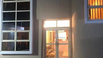 A building entrance with a glass door and windows.