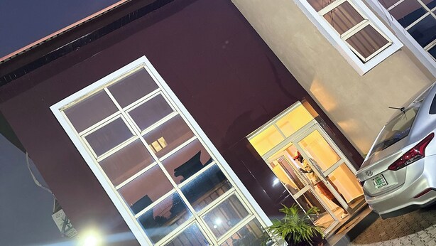 A building with large windows and a car parked in front. - Posh Apartments Metro (Lagos)