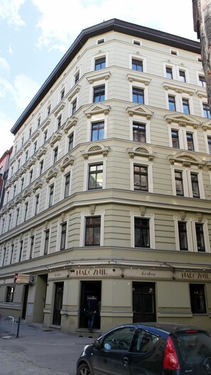 A multi-story building with a classical architectural style, featuring symmetrical windows and decorative moldings.