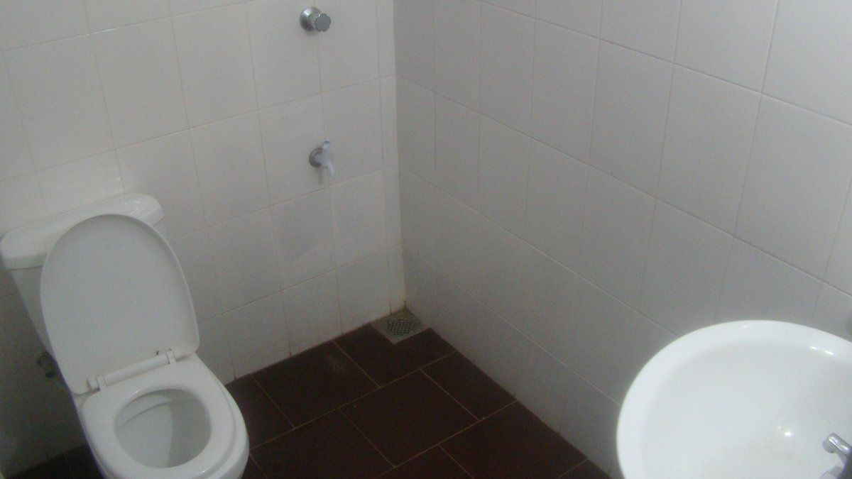A bathroom with a toilet, a bidet, and a sink.