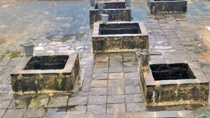 A rooftop with multiple square planters arranged in a grid pattern.