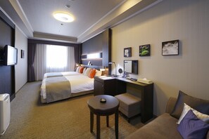 A hotel room with two beds, a desk, a chair, a TV, and artwork on the walls. - Viale Osaka (Osaka)