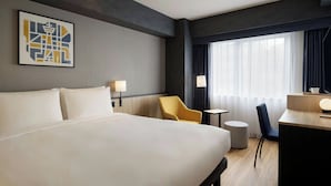 A hotel room with a large bed, a desk, a chair, a small table, and a window with curtains. - City Express By Marriott Osaka Shin-Imamiya (Osaka)