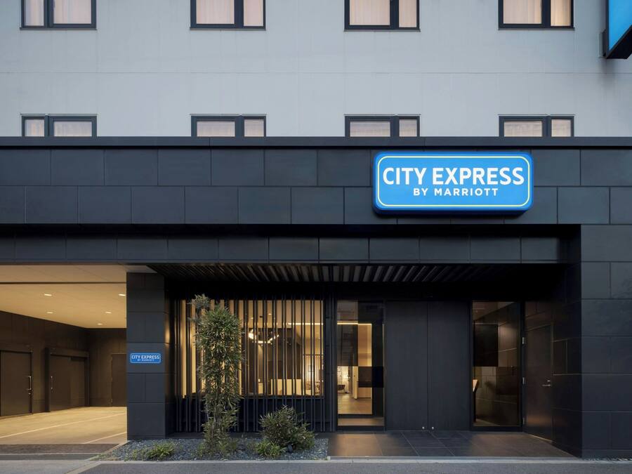 A modern building with a sign reading 'CITY EXPRESS BY MARRIOTT'.