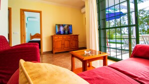 A hotel room with a bed, a wooden cabinet, a television, and a window with a view of the outdoors. - Roquetas Beach & Playa Serena Golf (Roquetas de Mar)