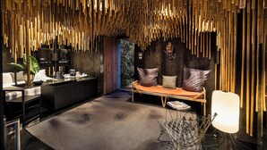 Un intérieur moderne avec un plafond en bambou, un canapé, un bureau et une lampe.
