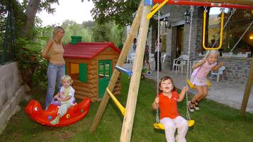 Children can play on the swing set, slide, and in the colorful playhouse.