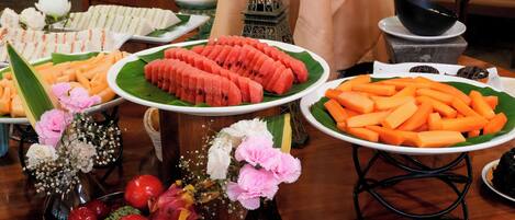 A buffet table with various food items and a decorative Eiffel Tower model.