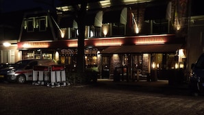 A hotel with a brick facade, a sign reading "HOTEL DUHOCHEX," and a catering van parked in front. - Hotel Duhoux Leeuwarden (Wirdum)