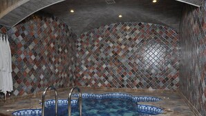 A spa area with a mosaic-tiled wall, a small pool, and a shower area. - Joyy Hotel & Spa (Baku)