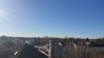 A residential area with houses, a clear sky, and distant mountains.