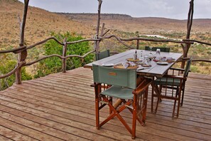 Enjoy a romantic meal on the deck with a serene hilly view.