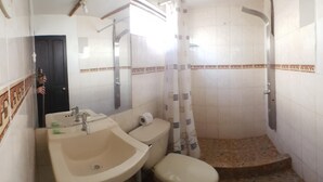 A bathroom with a sink, toilet, and shower. - La Cabaña Hotel (Cusco)