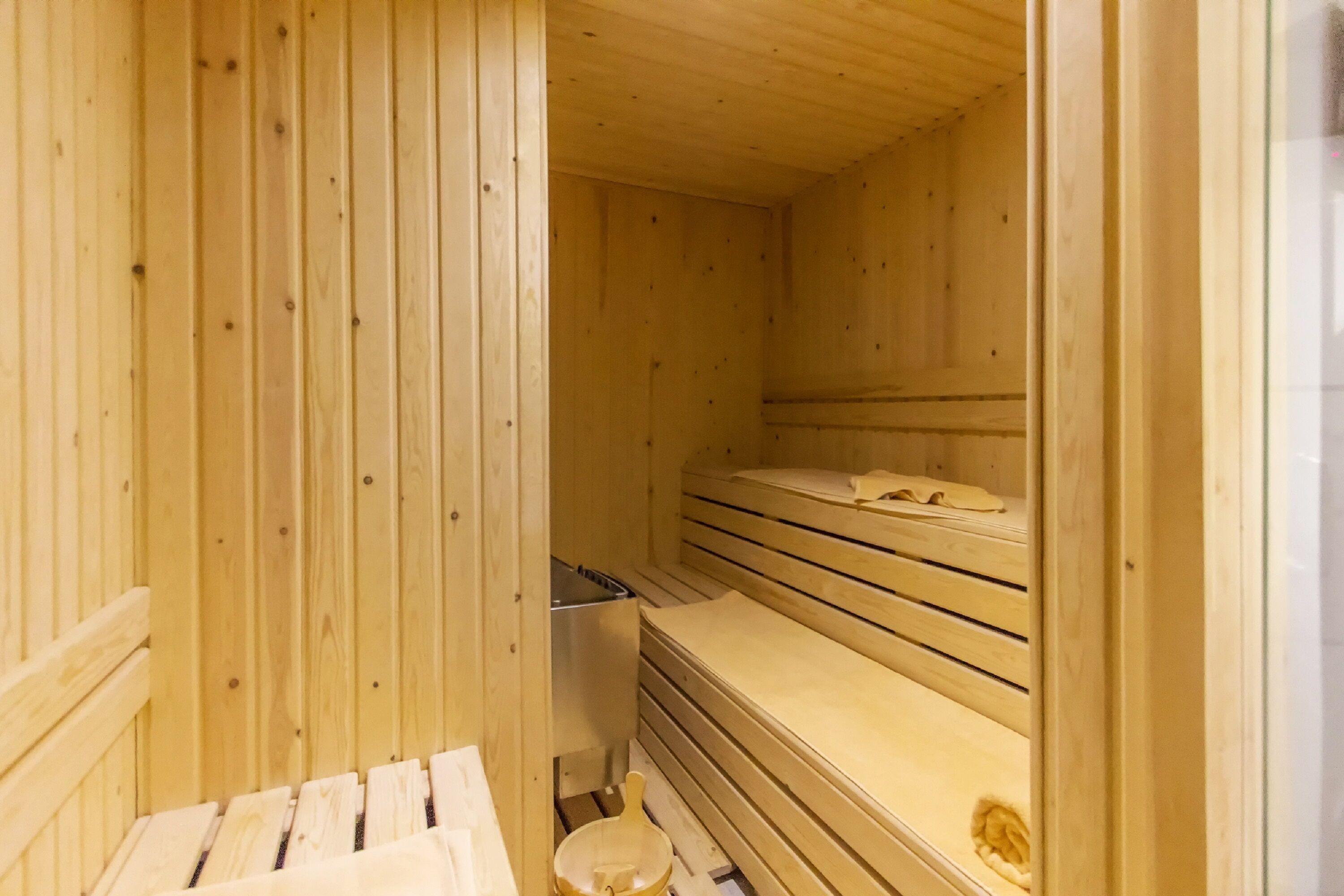 A sauna room with wooden walls and benches.