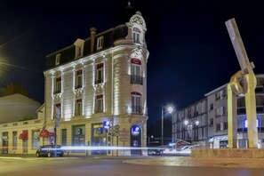 A historic hotel with a classic European architectural style, featuring a prominent corner tower and multiple balconies. - Elysée Hotel (Chateauroux)