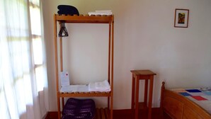 A room with a bunk bed, a small wooden table, and a bed with a quilt. - La Casa de Cafe (Copan Ruinas)