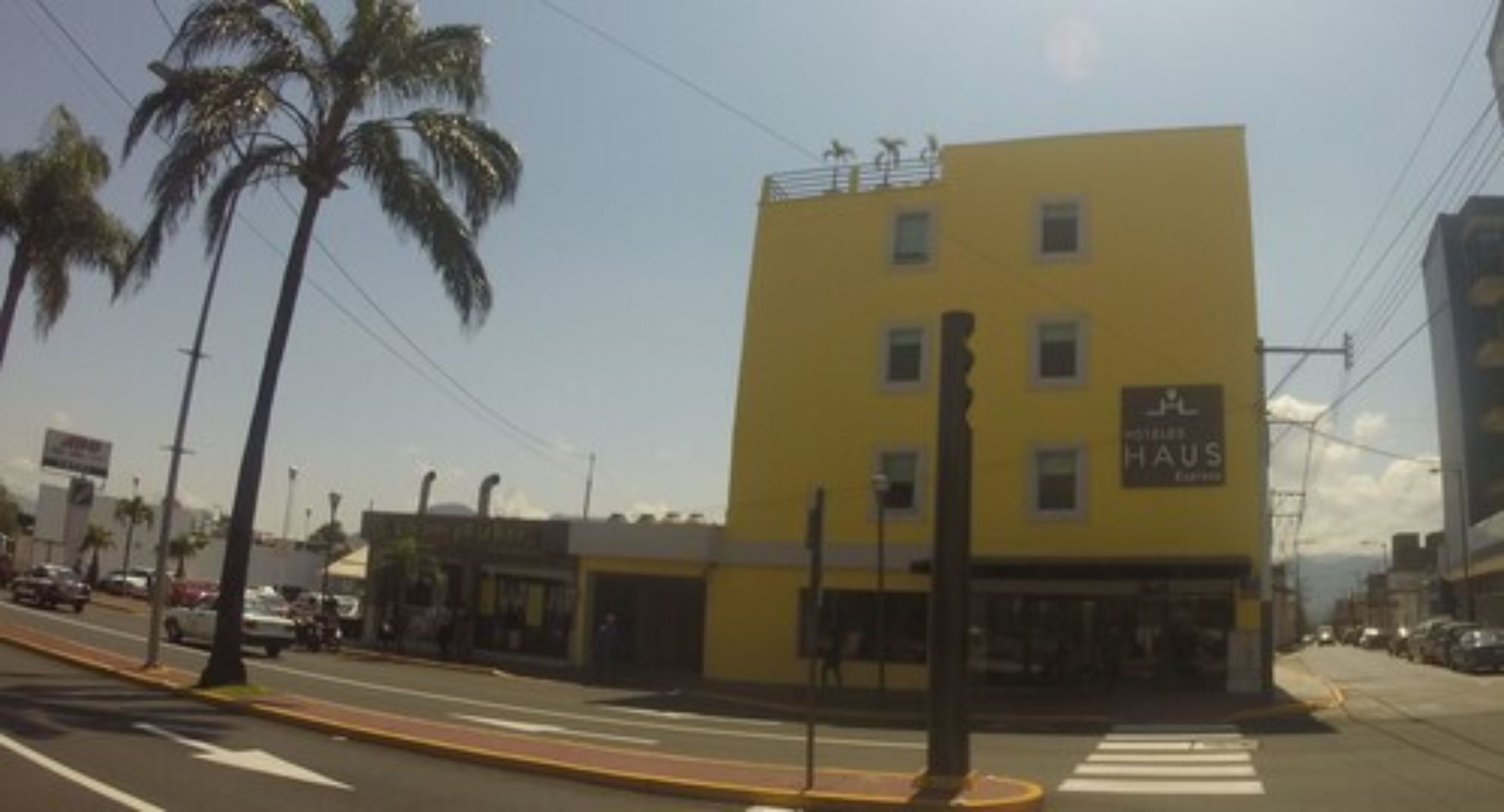 A yellow building with a sign that reads "HOTEL HAUS."
