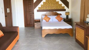 A bedroom with a bed, a sofa, a nightstand, and a dresser. - Brazaville Beach Resort (Hinoba-an)