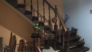 A staircase with wooden railings and multiple potted plants hanging from the handrails. - Zleep63 - Hostel (Bangkok)