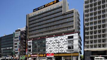 A hotel with a modern facade, multiple floors, and a prominent sign for VIA INN.