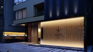 A modern hotel facade with illuminated signage for "CANDEO HOTELS" and a star logo. - Candeo Hotels Osaka Namba (Osaka)