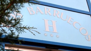 Un cartel con el texto "BARRUECOS H" en la fachada de un edificio.