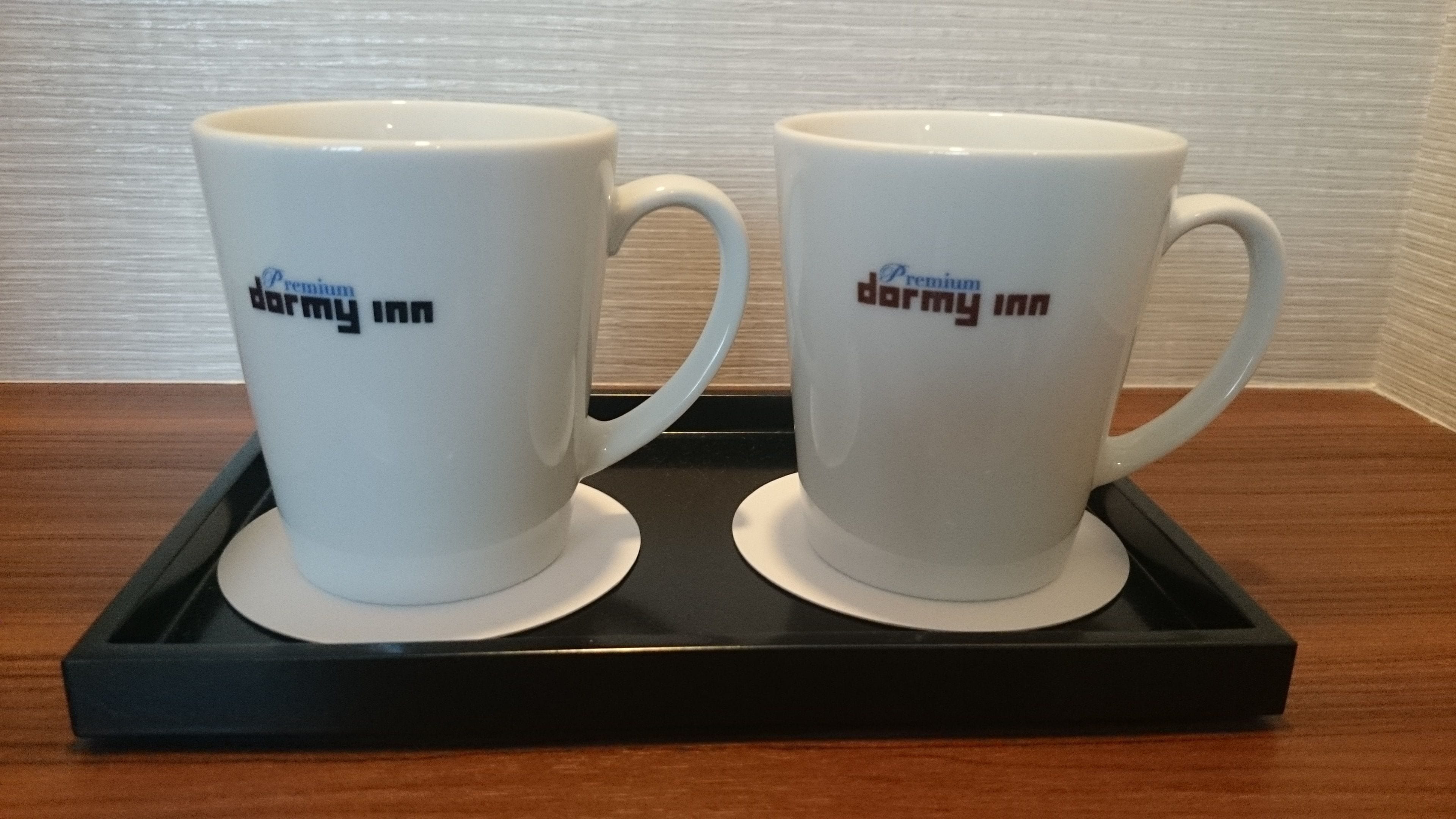 Two white mugs with "Premium Army Inn" text on a black tray.