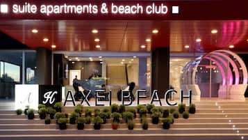 A hotel entrance with a sign reading "suite apartments & beach club".