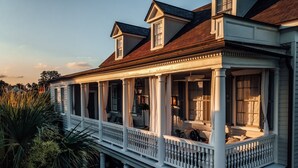 A large, two-story house with a covered porch and multiple windows. - 86 Cannon Charleston - Adults Only (Charleston)