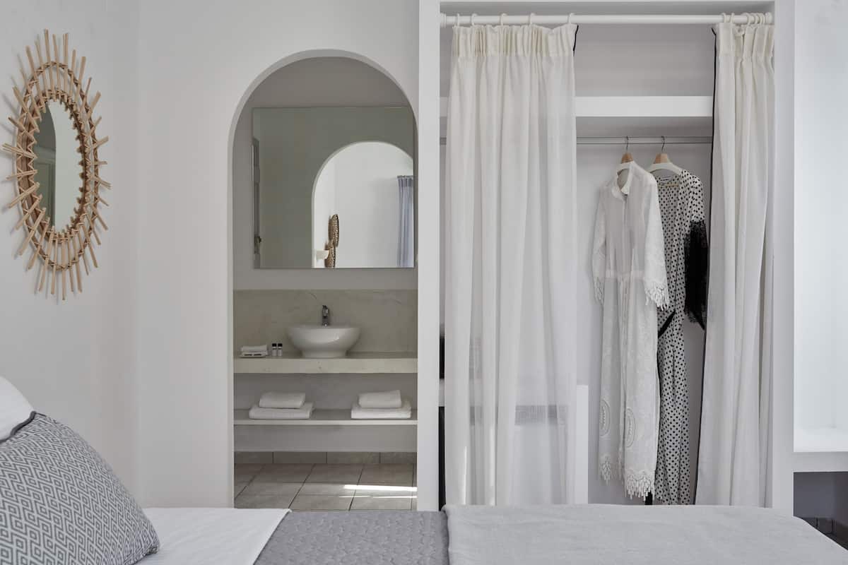 A modern bathroom with a freestanding sink, a mirror, and a shower curtain.