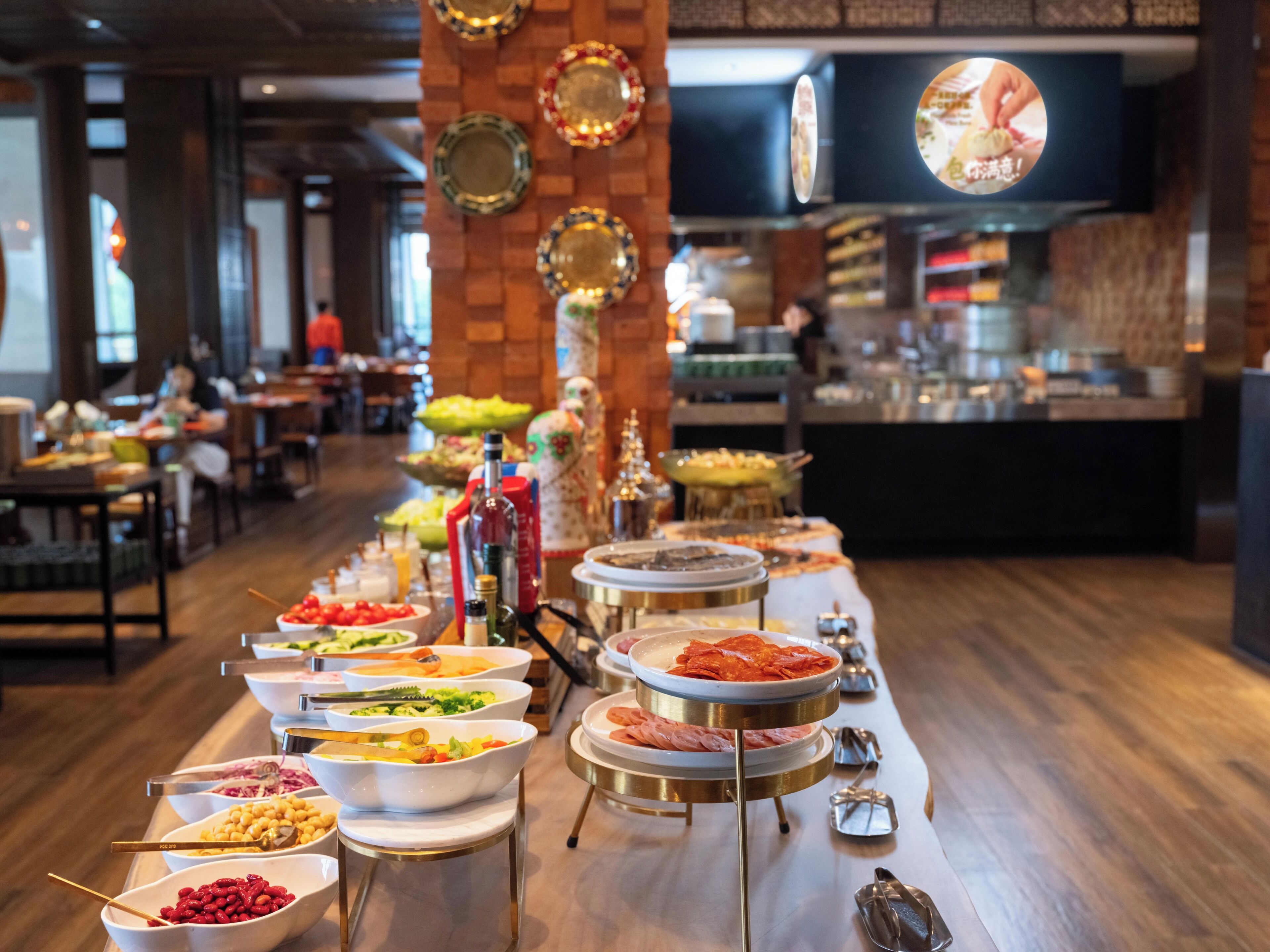 A buffet setup with various food items and utensils.