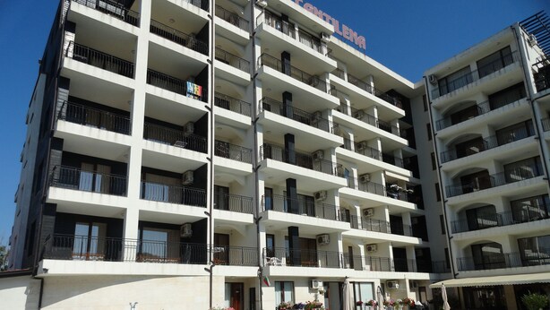 A multi-story hotel with a swimming pool, balconies, and outdoor seating areas. - Cantilena Complex (Sunny Beach)