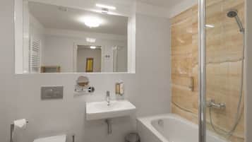 A modern bathroom with a toilet, sink, and bathtub.