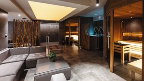 A modern lobby with seating areas, a reception desk, and a visible elevator. - Hotel Frýdl (Prague)