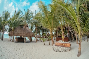 A beach with palm trees, a thatched-roof hut, and a sign reading 'BAR FRONTERA'. - El Dorado Seaside Palms, All & More Inclusive - Adults Only (Kantenah)