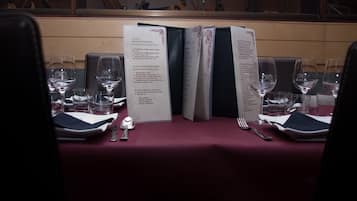 A table set for dining with menus, glasses, and cutlery.