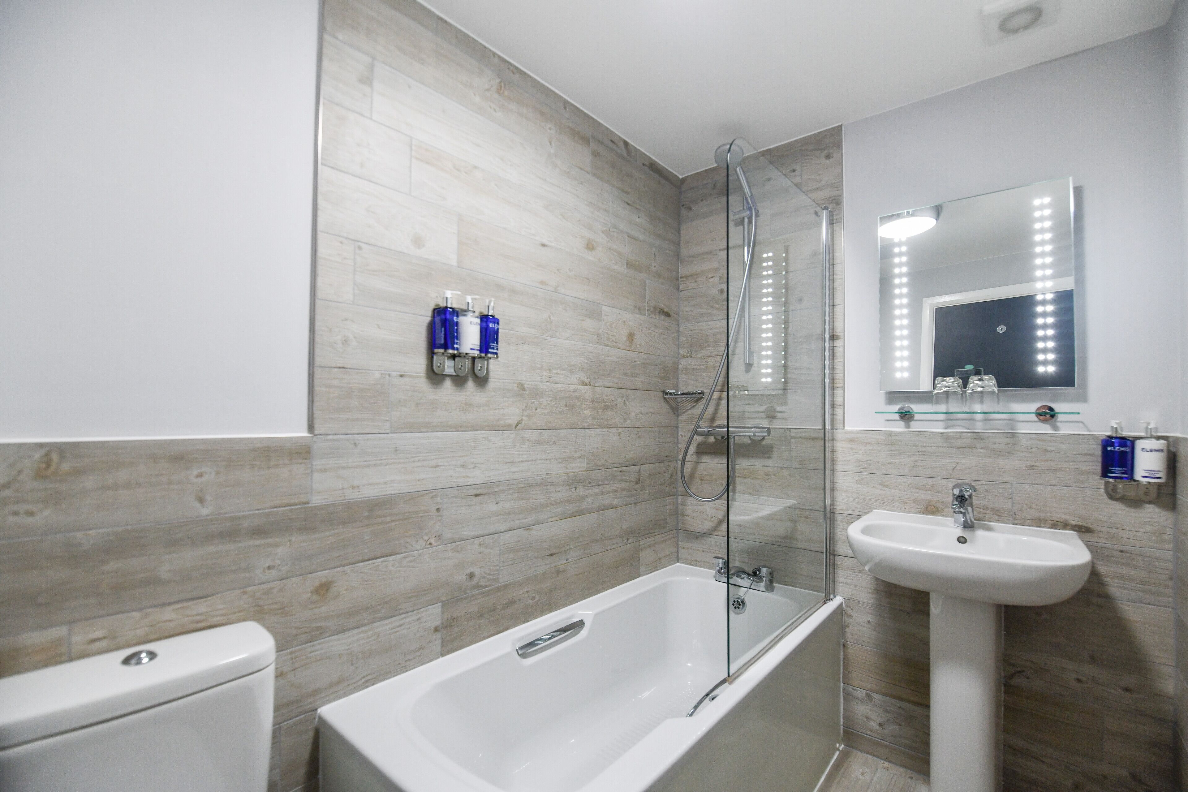 eco-friendly toiletries, hair dryer, slippers, towels