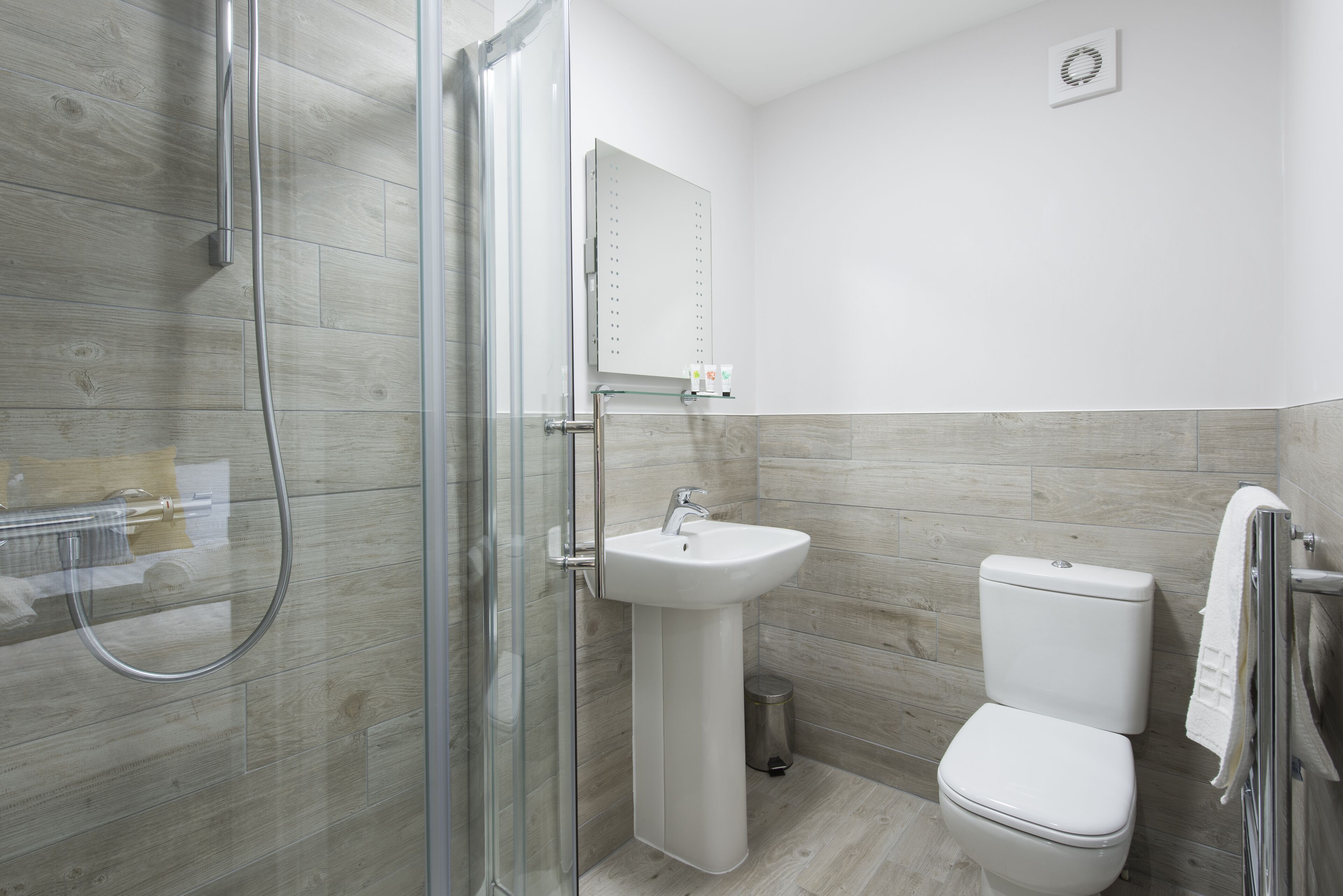 eco-friendly toiletries, hair dryer, slippers, towels