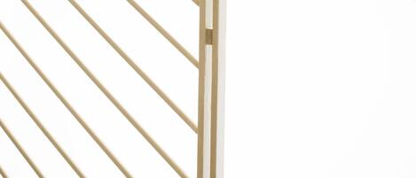 A staircase with a metal railing and sheer curtains.