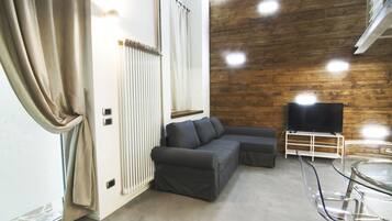 Departamento, 1 habitación | Área de sala de estar | Televisión de pantalla plana