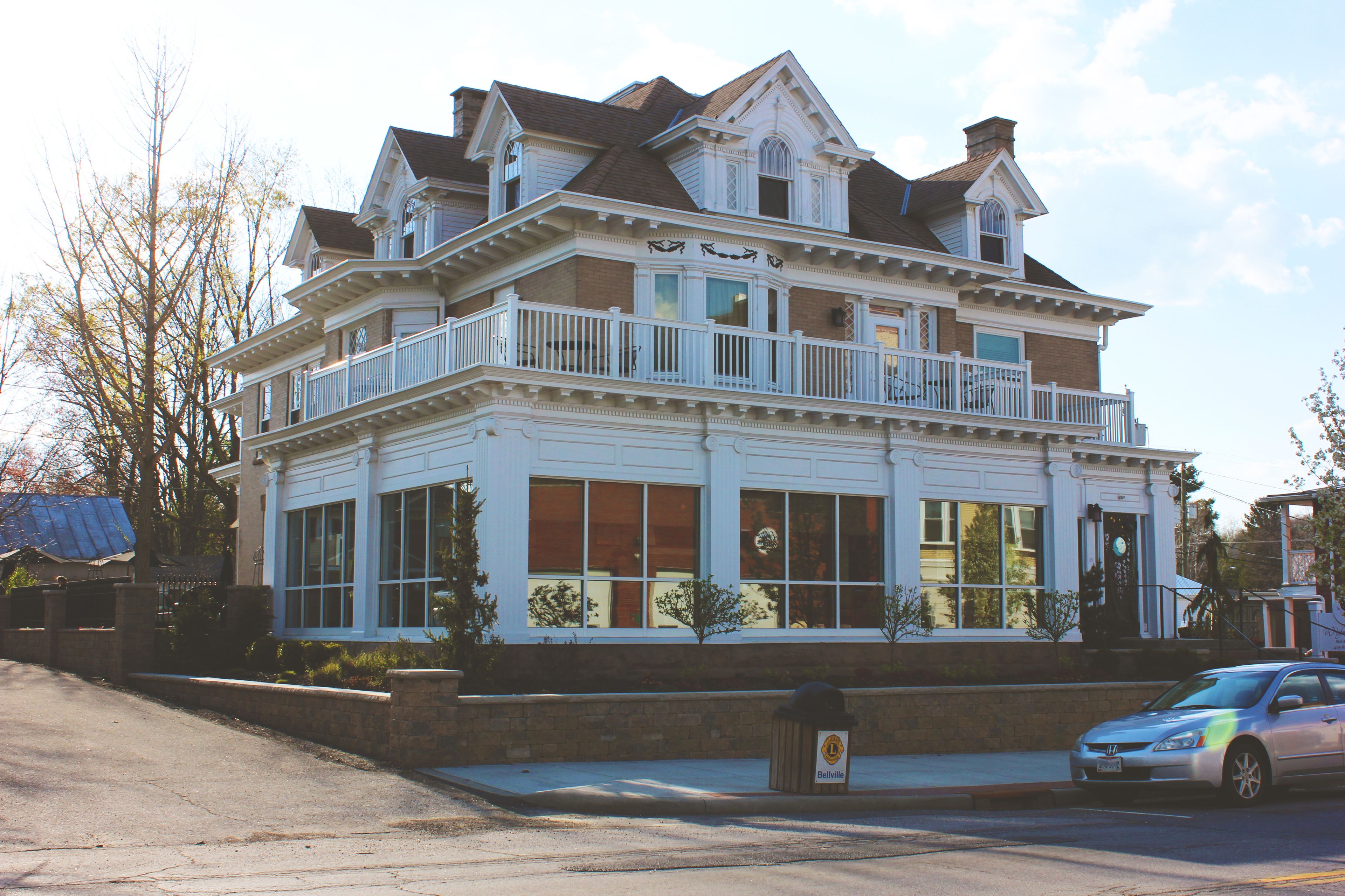 A large, two-story building with multiple balconies and large windows.