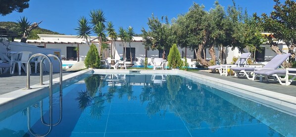 Een seizoensgebonden buitenzwembad, parasols voor strand/zwembad