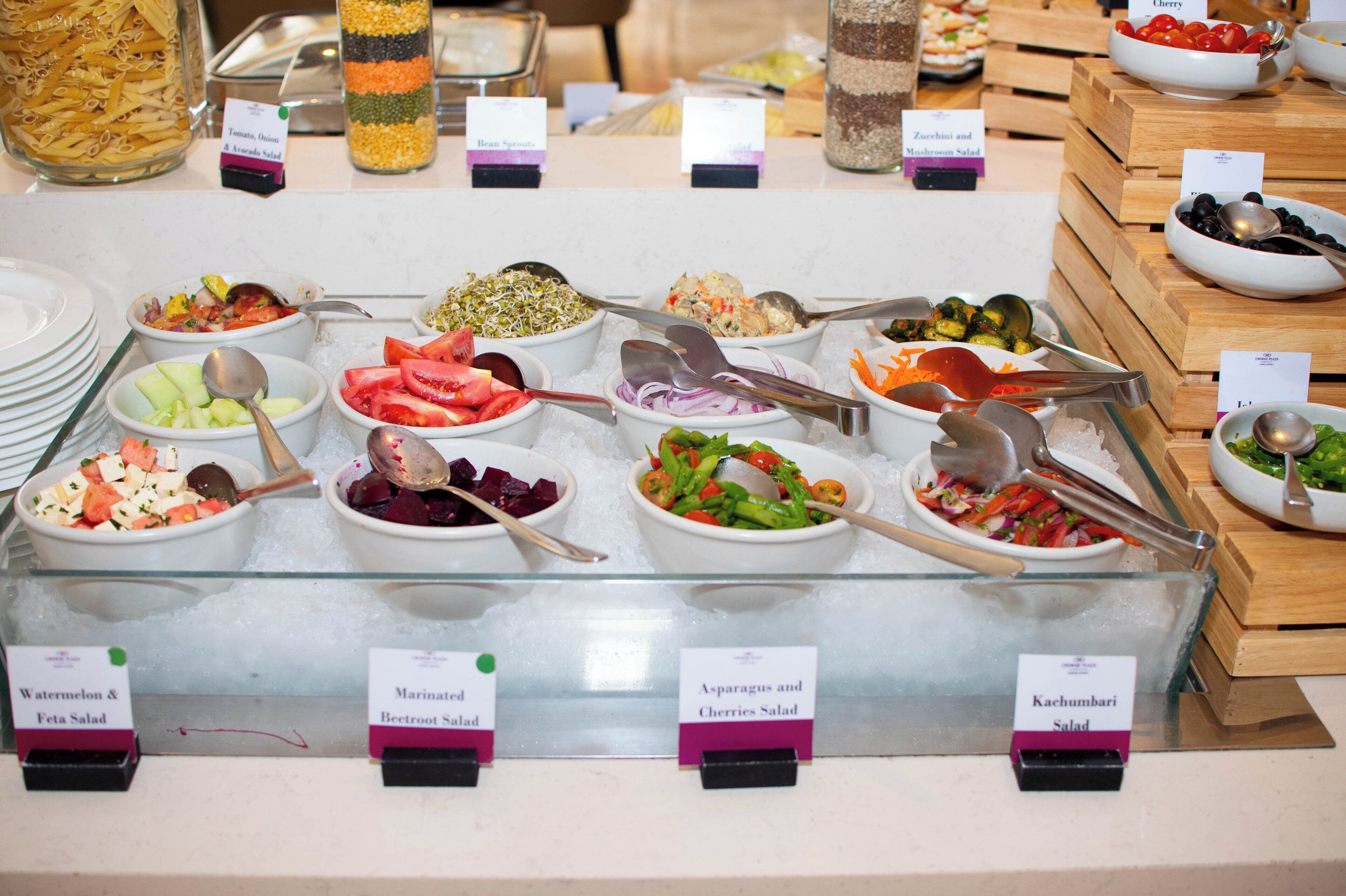 A buffet with various salads and pasta dishes.