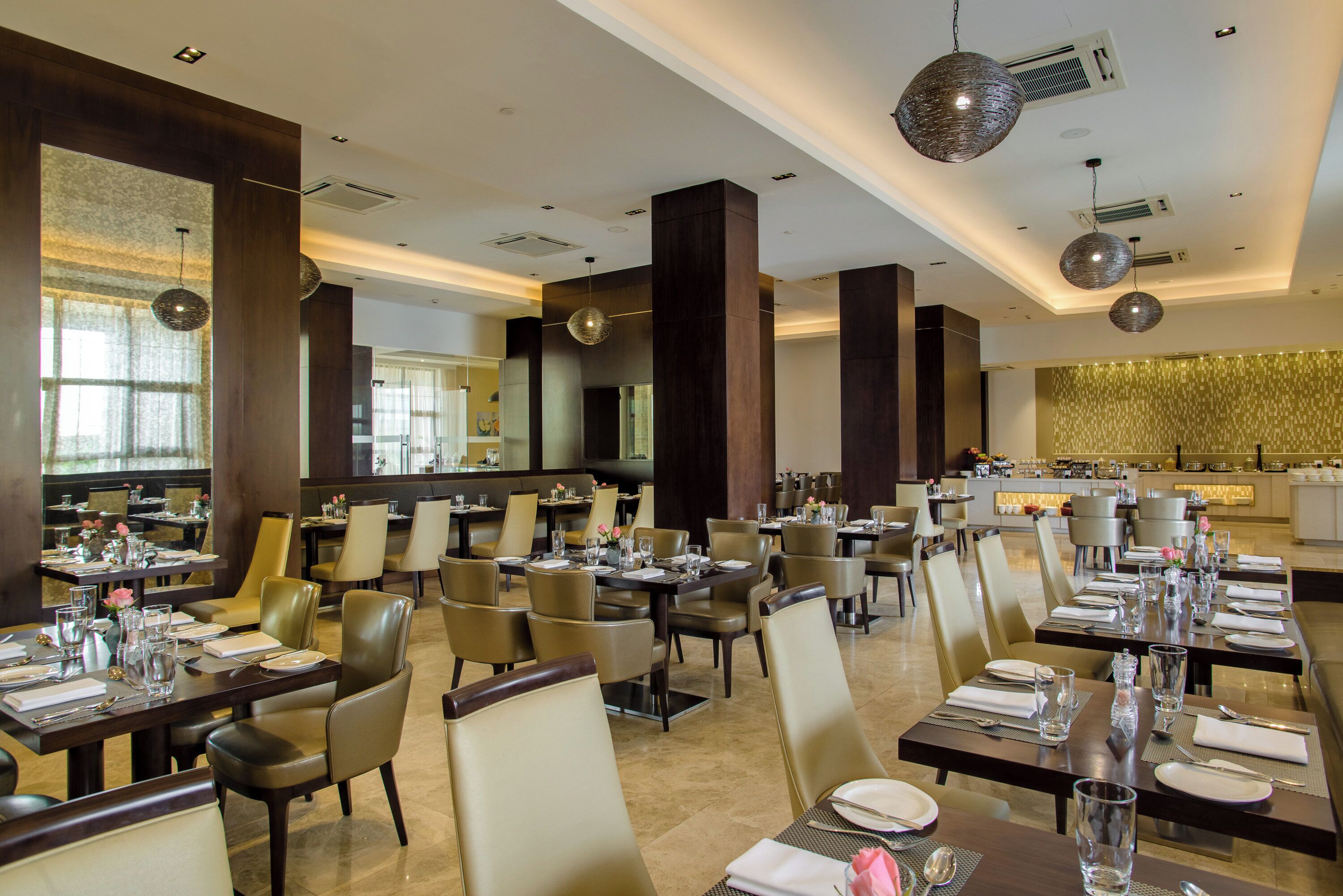 A spacious restaurant with high ceilings, modern decor, and ample seating.