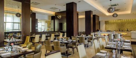 A spacious restaurant with high ceilings, modern decor, and ample seating.