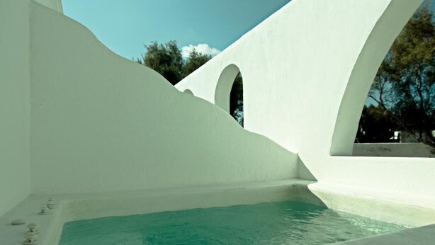A modern white building with a pool and arched windows. - Santorini Breeze (Santorini)